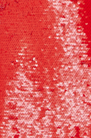 Close-up of red sequin fabric from a mini skirt with reflective shine