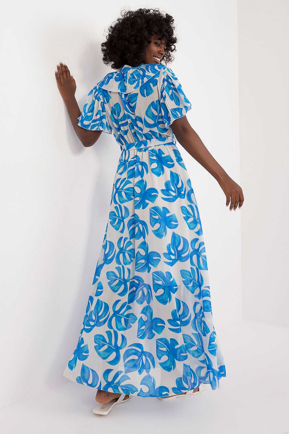 Summer floral dress with ruffled short sleeves, heart neckline, tie belt, and blue leaf print, showcasing elegance and femininity for warm days.