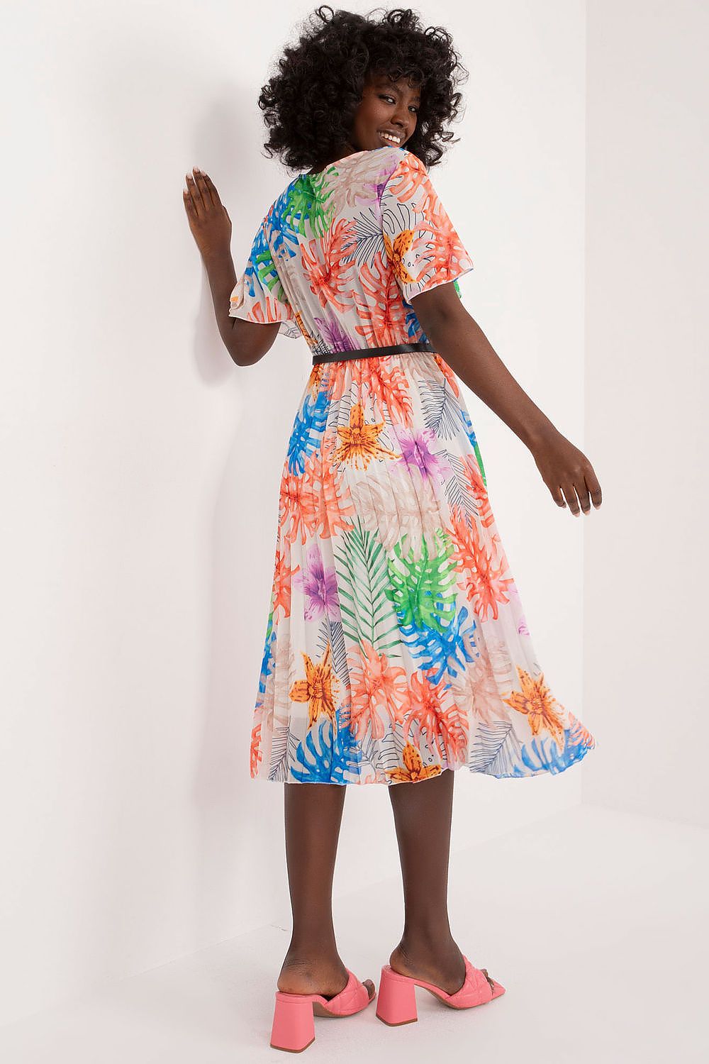 Summer floral dress with short sleeves and envelope neckline, featuring a pleated bottom hem and belt.