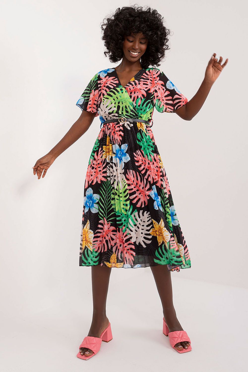 Summer floral dress with flared cut, short sleeves, and envelope neckline in vibrant colors.