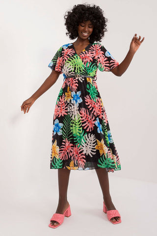 Summer floral dress with flared cut, short sleeves, and envelope neckline in vibrant colors.