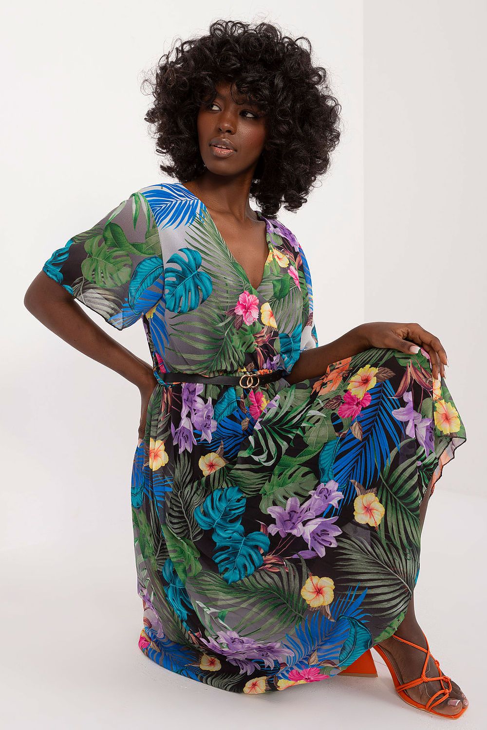 Summer floral dress with envelope neckline and pleated hem, featuring vibrant floral pattern, short sleeves, and a belt.