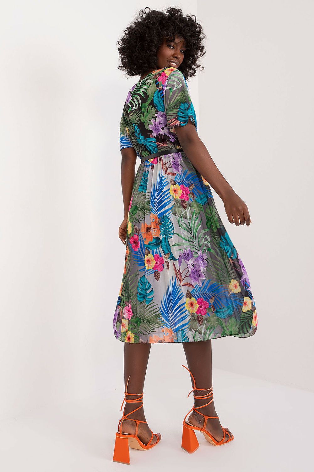 Summer floral dress with flared cut, envelope neckline, and pleated hem.