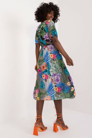 Summer floral dress with flared cut, envelope neckline, and pleated hem.