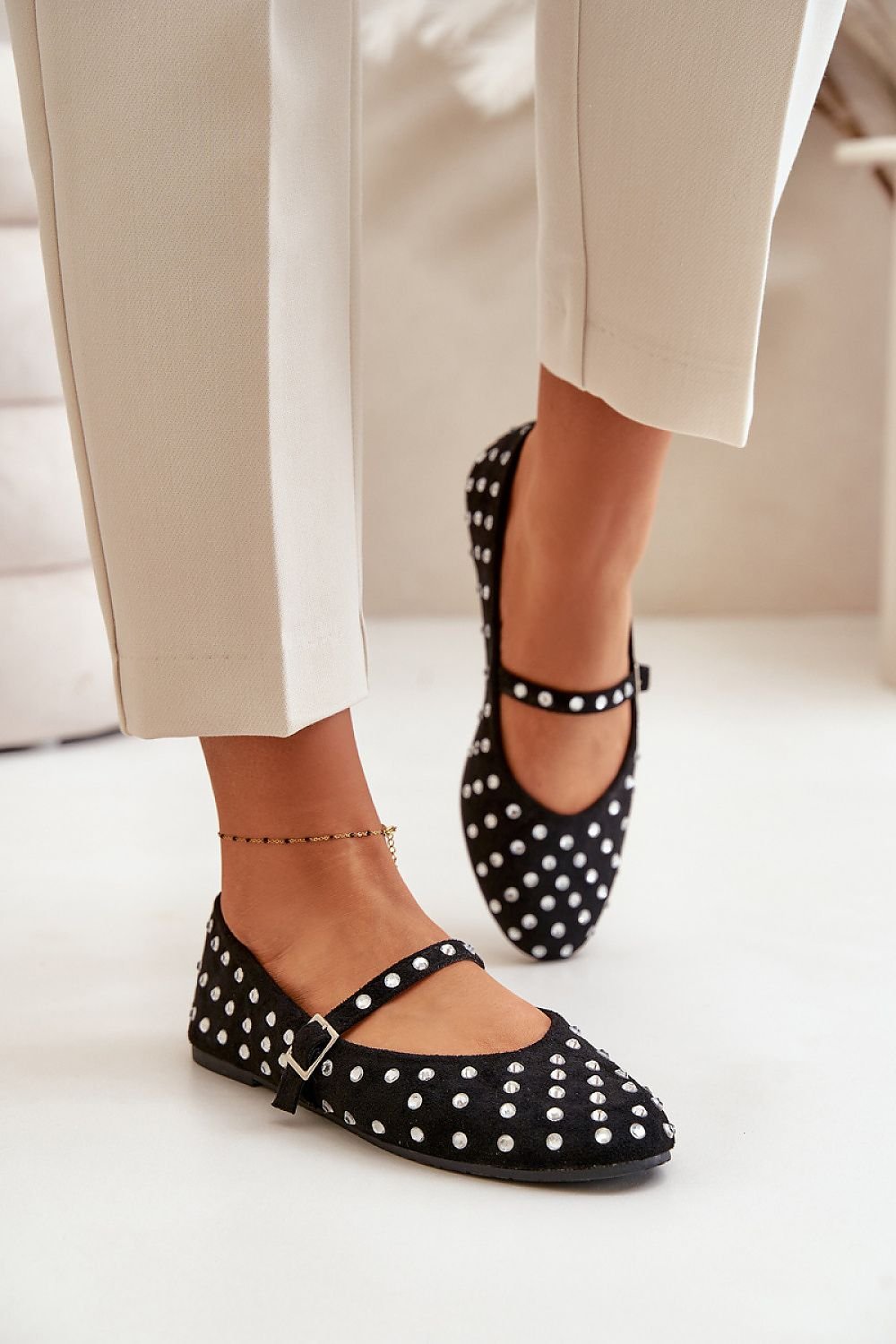 Eco suede ballet flats with zircon-like jets and adjustable strap.