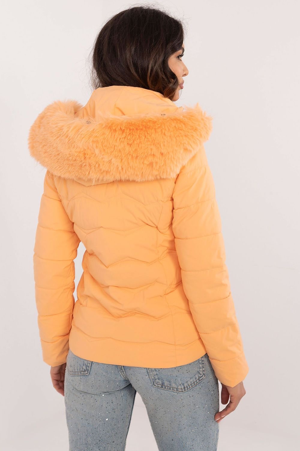 Women’s winter jacket with quilted design, hood, and zipper closure in orange.