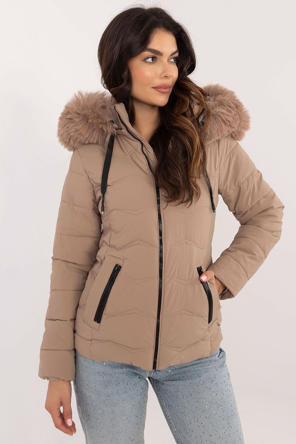 Women’s winter jacket with quilted design, zip closure, and detachable hood, featuring side zippered pockets for cold weather style.