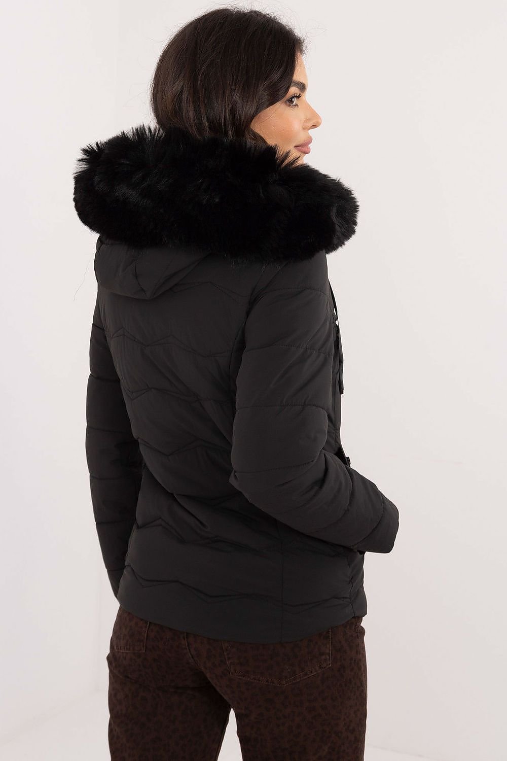 Women’s winter jacket with quilted design and faux fur hood, ideal for cold weather.