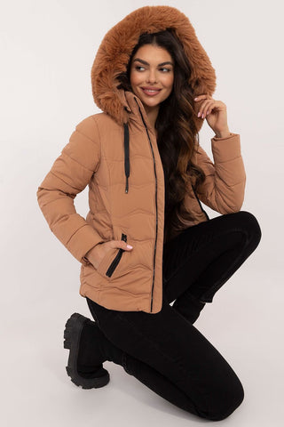 Women wearing a stylish quilted women’s winter jacket with a faux fur hood, suitable for cold weather.