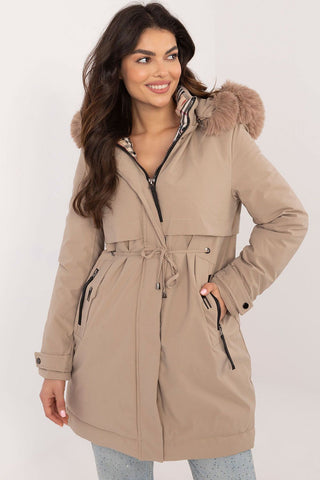 Transitional Jacket with detachable fur hood and waist belt in beige.