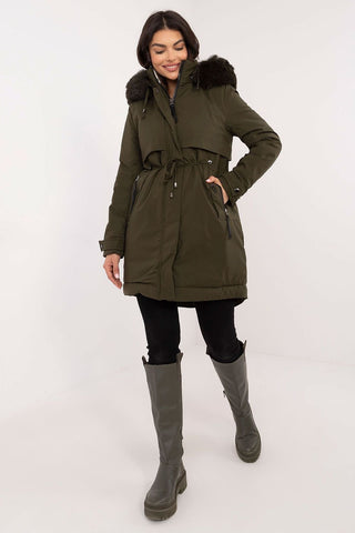 Transitional jacket with quilted design, detachable fur, and hood, featuring a waist belt and zippered pockets.