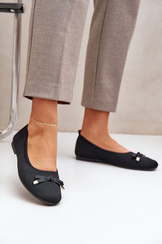 Women's black ballet flats with a small bow, mesh design, and eco-leather insole.