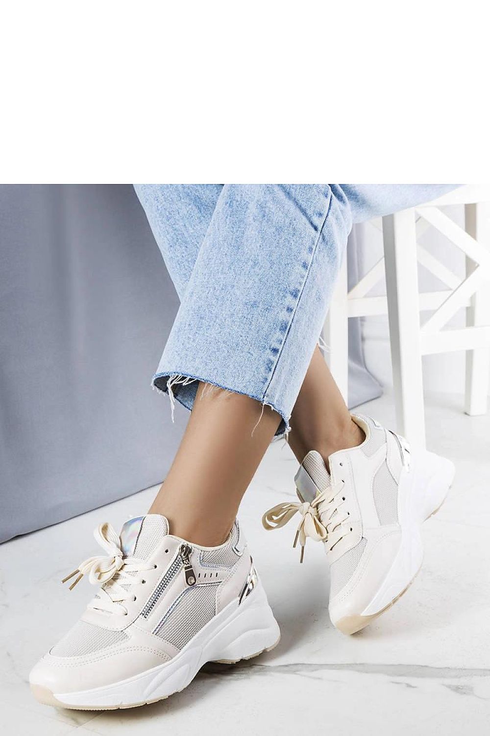 Limited edition beige wedge sneakers with white rubber sole and laced design.