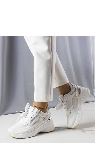 Limited edition Ani beige wedge sneakers with white soles and laced design.