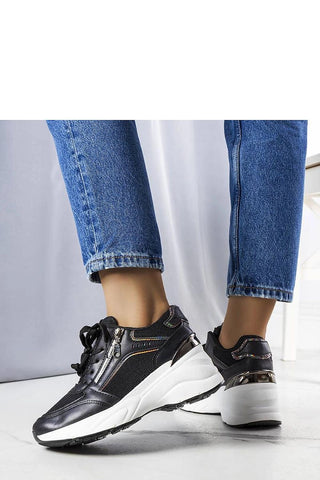 Limited edition black wedge sneakers with white sole and laces, showcased on a model wearing jeans.