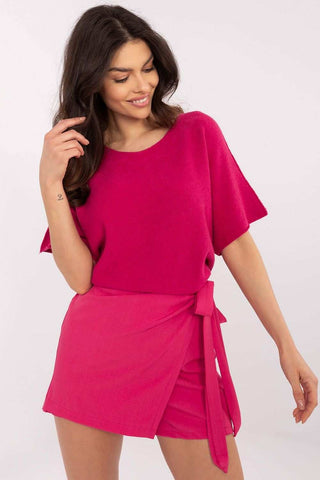 Elegant pink skirt pants with wide legs, high waist, and waist tie emphasizing feminine charm.
