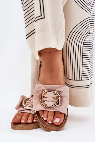 Beige flip-flops with faux suede and gold detail, enhancing summer outfits with elegance.