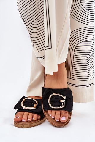 Beige flip-flops with faux suede and gold detail, perfect for summer outfits.