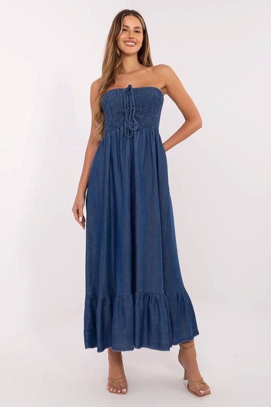blue sleeveless summer maxi dress with elastic ruched bodice and ruffled hem worn by smiling woman