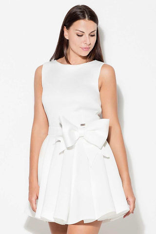 Women's short dress with wide straps and bow accent, fitted top, flared bottom, white.