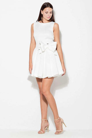 Women's short dress with wide straps and side bow, flared bottom, and covered zipper.