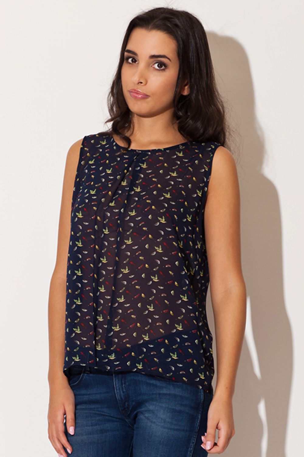 Sleeveless chiffon blouse with bird pattern and round neckline.