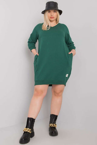Plus size green dress with 3/4 sleeves and pockets.