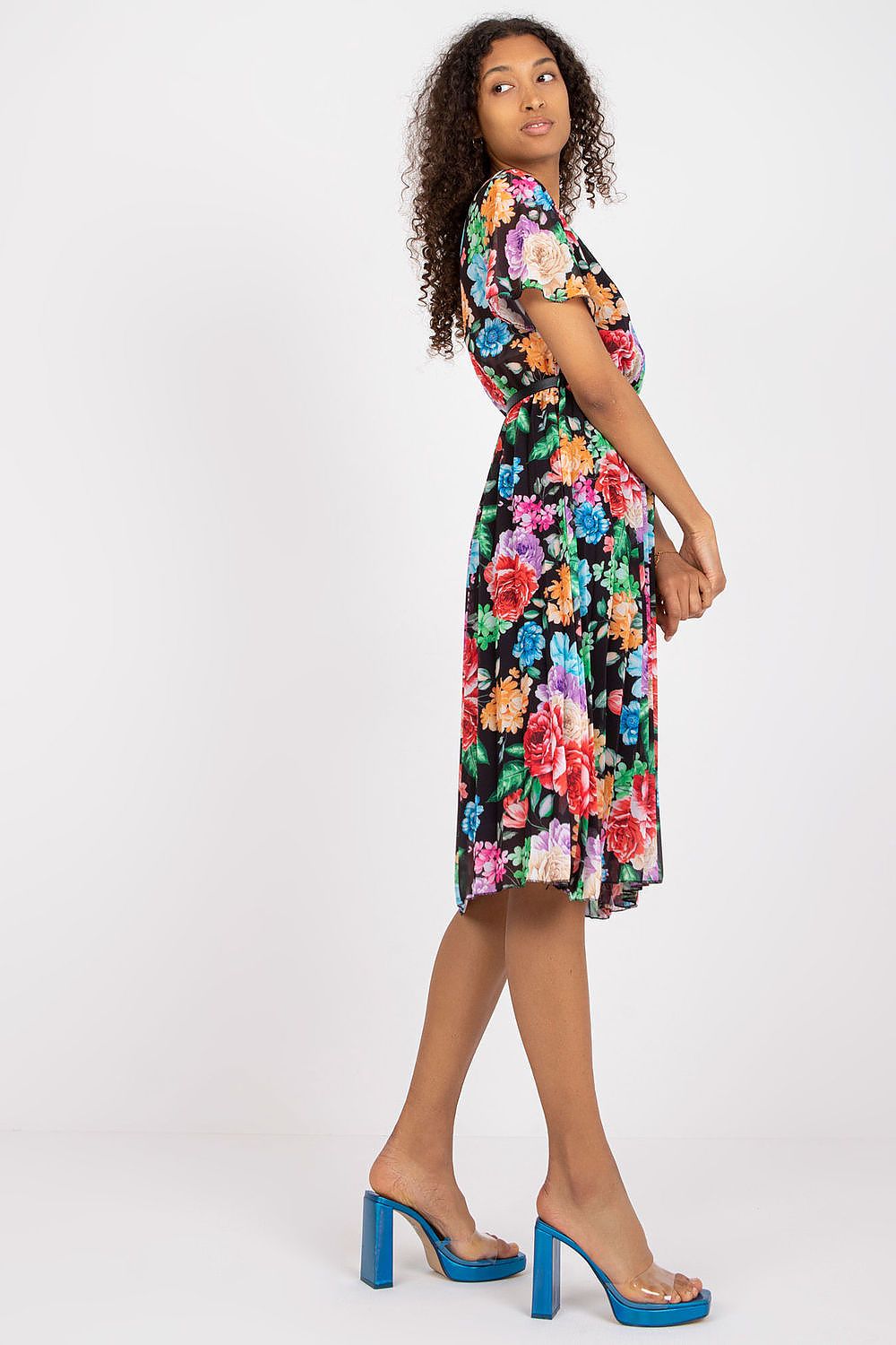 Summer floral dress with short sleeves, envelope neckline, and pleated hem.