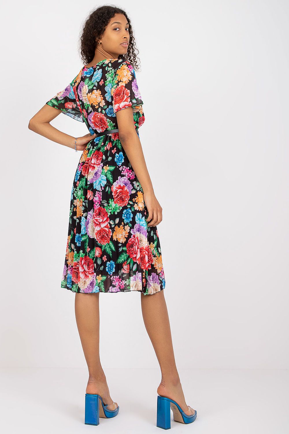 Summer floral dress with flared cut, envelope neckline, and pleated hem.