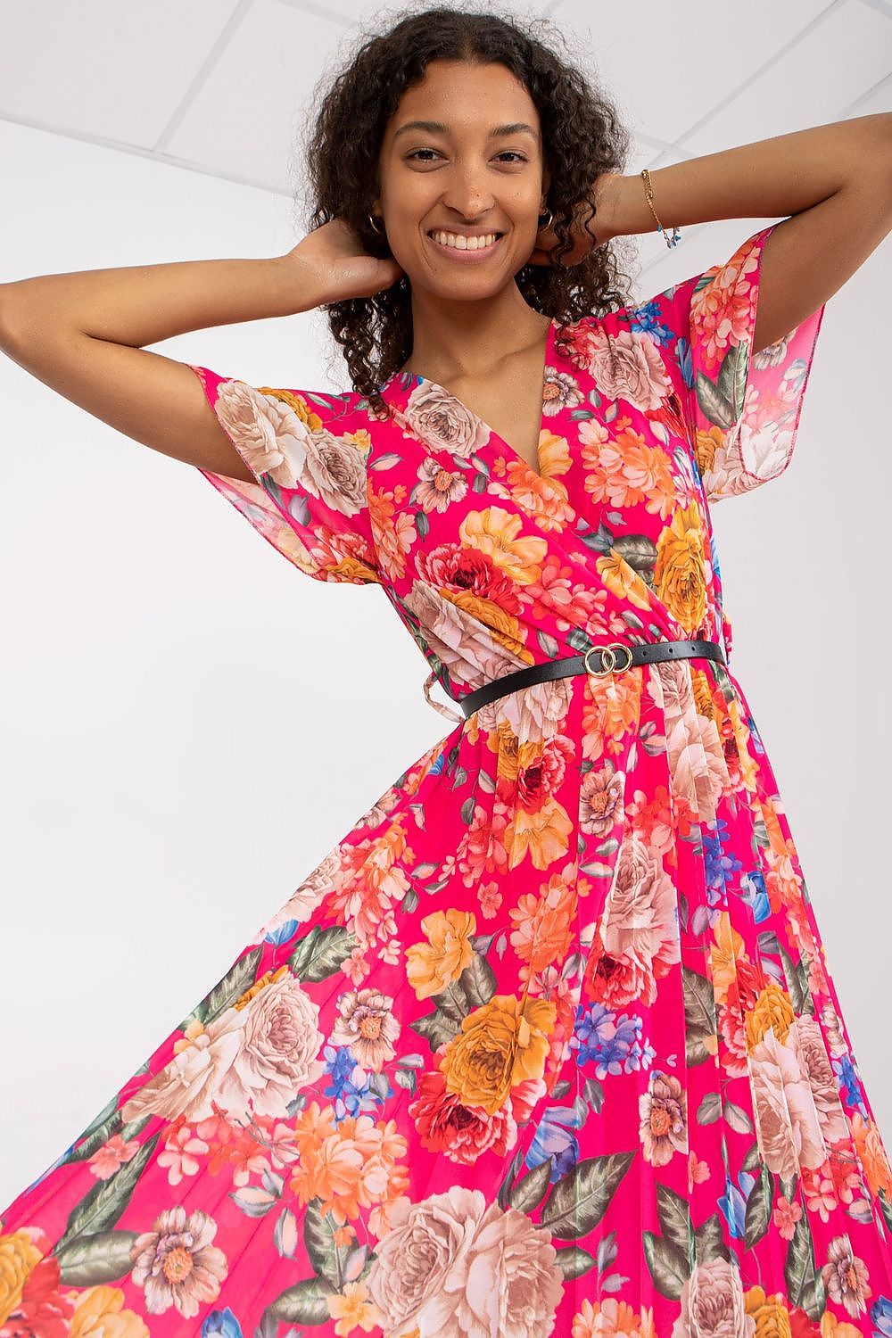 Summer floral dress with flared cut, short sleeves, envelope neckline, and pleated hem.