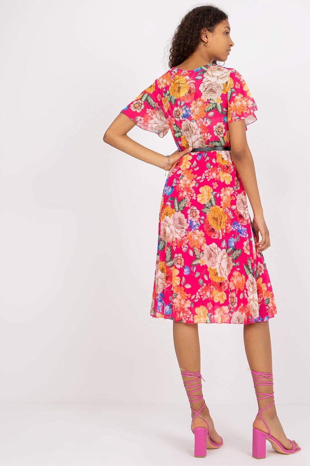 Summer floral dress with flared cut, envelope neckline, and pleated hem.