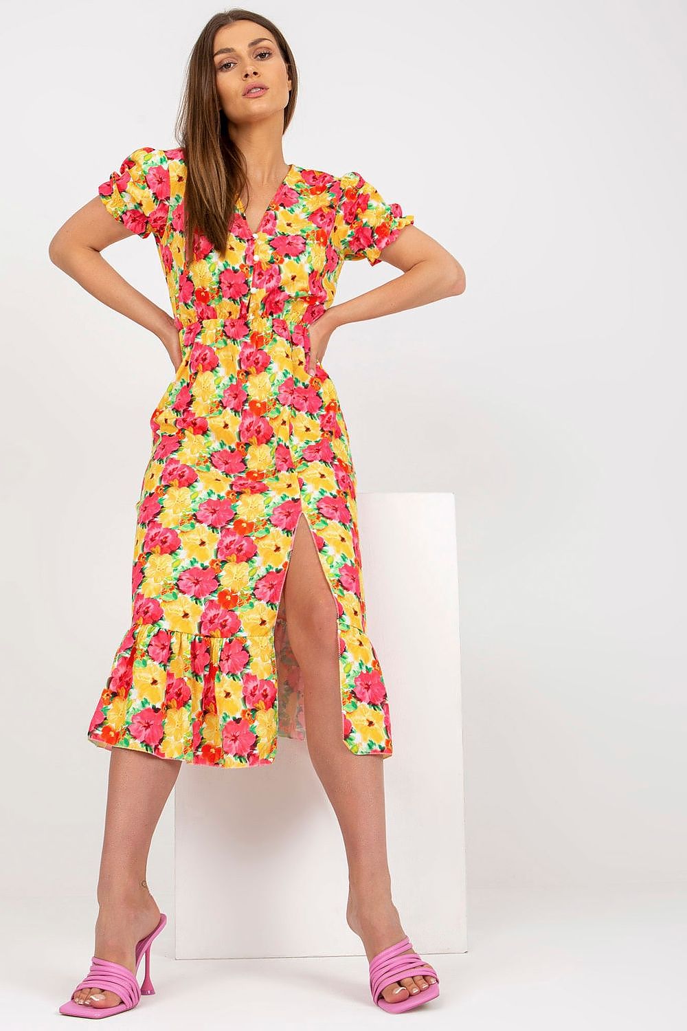 Women's summer floral dress with buttoned front, bottom slit, and frill.