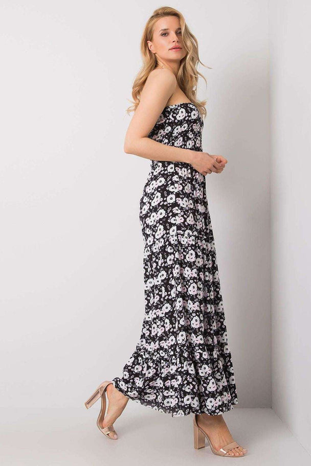 Long summer dress with floral pattern and ruffle hem, worn by a model.
