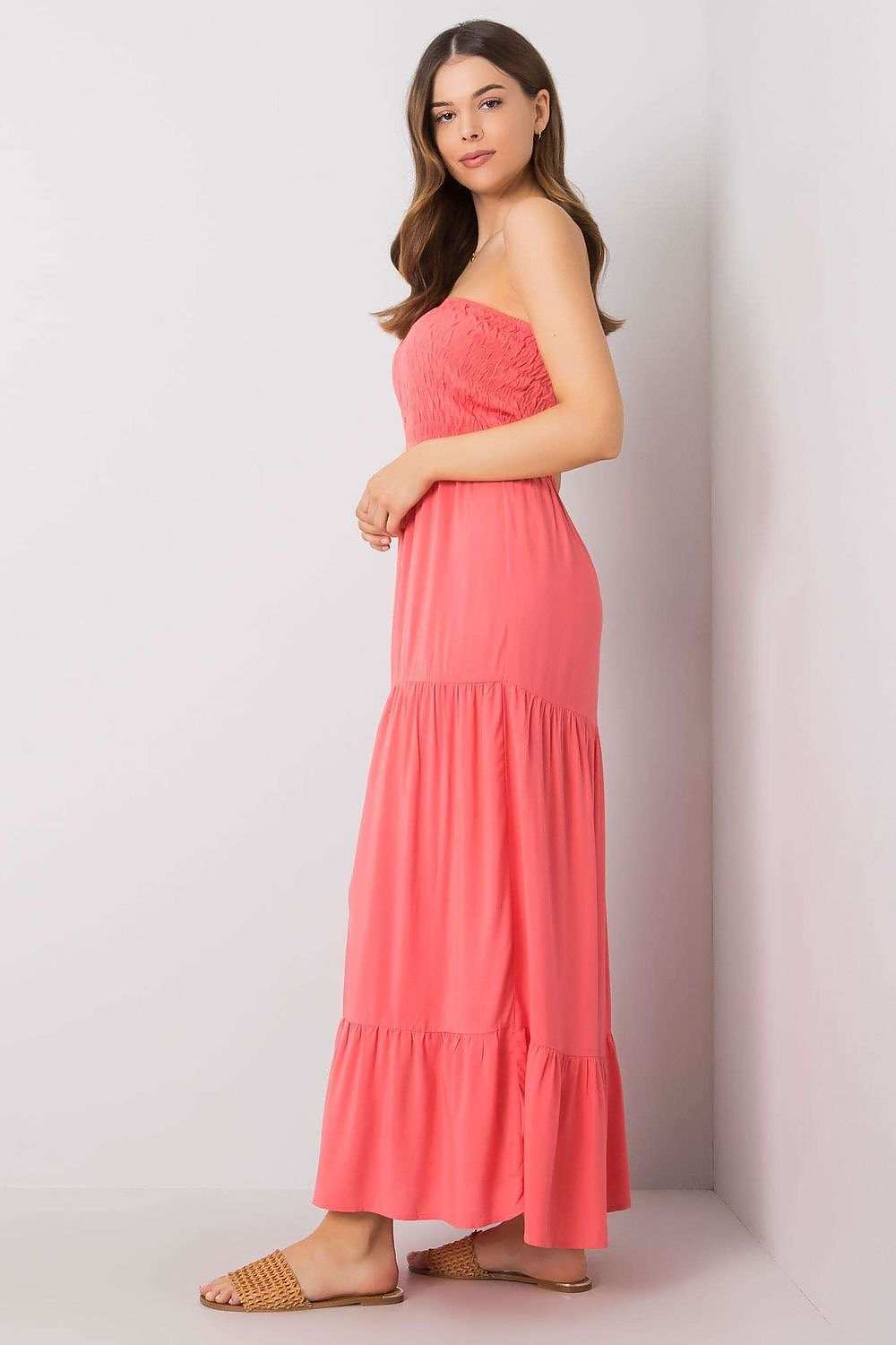 Long strapless summer dress with ruffle bottom and supportive elastics, perfect for warm days.