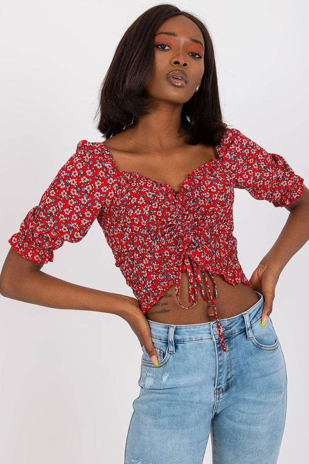Red women's crop top with floral pattern, ruched front, puff sleeves, and heart-shaped neckline in lightweight viscose fabric