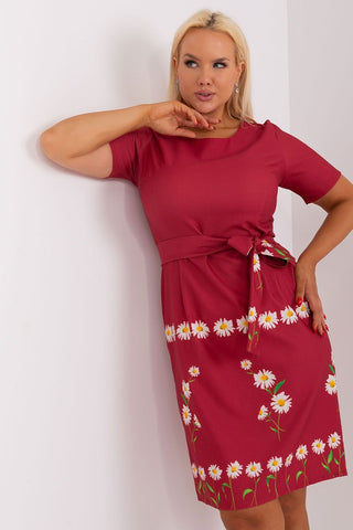 Plus size dress with floral print, short sleeves, round neckline, and waist tie.