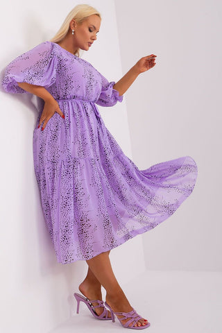 Plus size purple dress with 3/4 sleeves and round neckline.