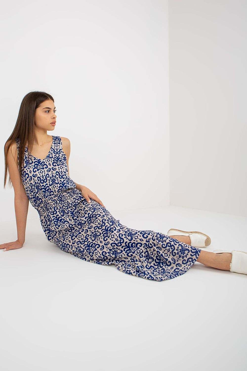 Summer floral dress with thick straps and heart neckline, featuring a cinched waist and ruffled hem.