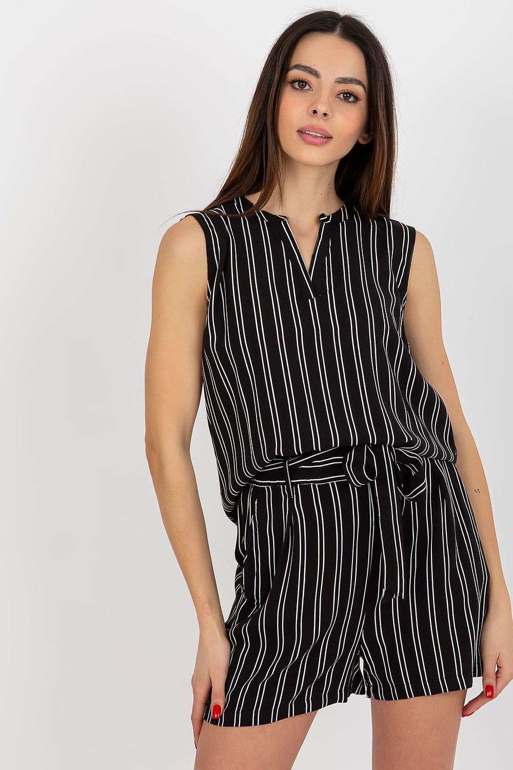 Sleeveless floral blouse with heart neckline and patterned fabric.