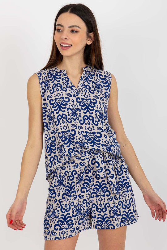 Sleeveless floral blouse with heart neckline and patterned fabric.